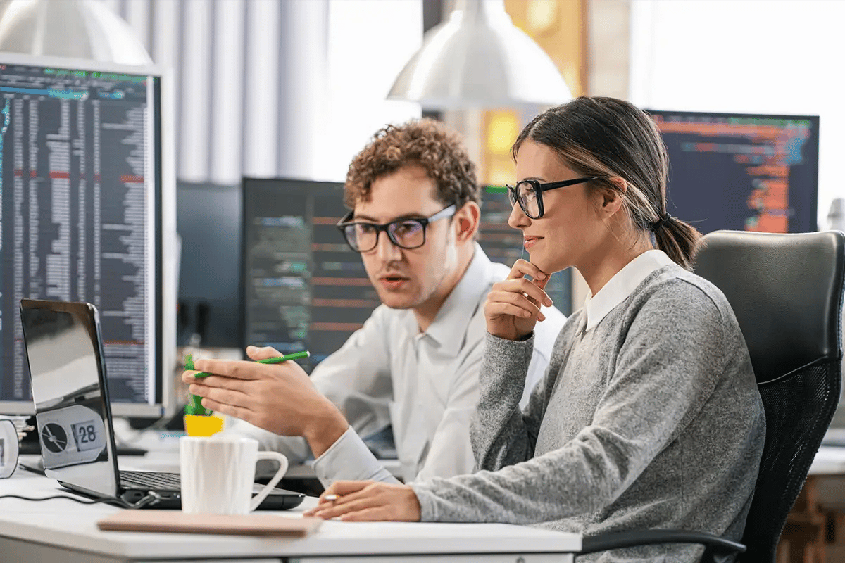 A man and a woman working with OTT and Video Performance Monitoring