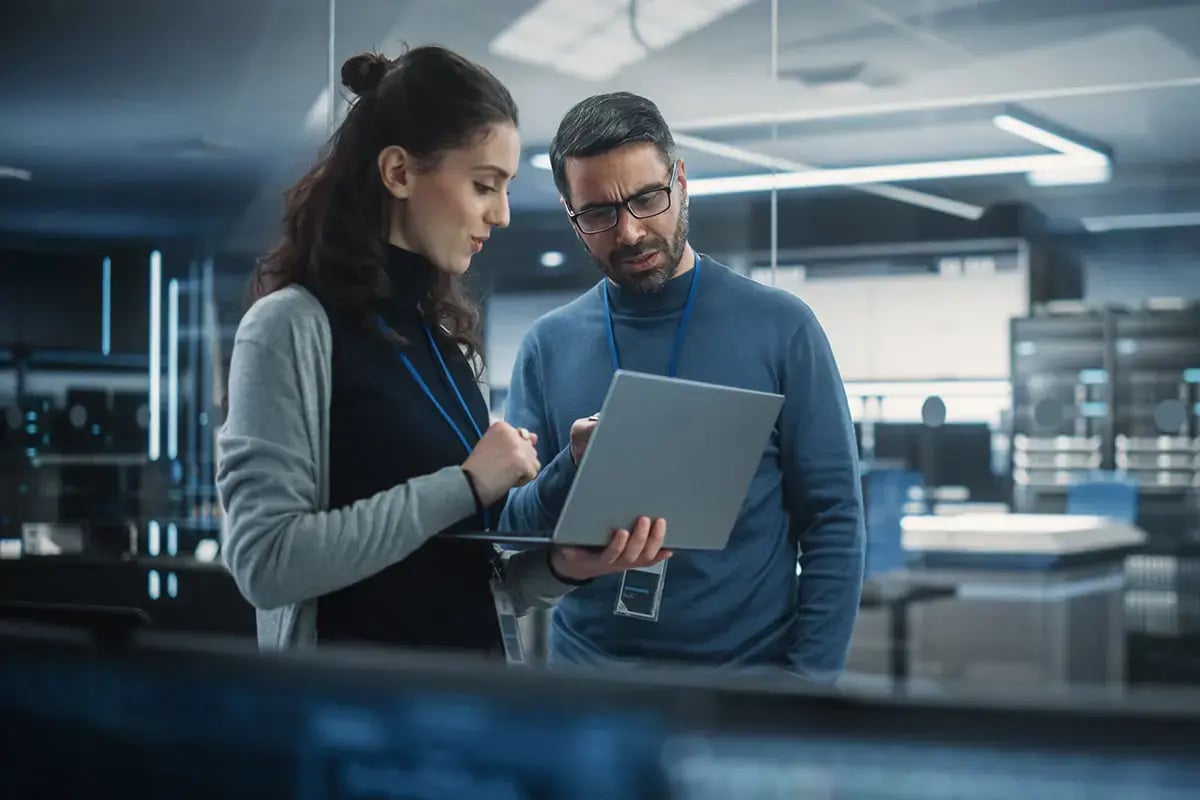 A man and a woman working in 5G SA Core Operations