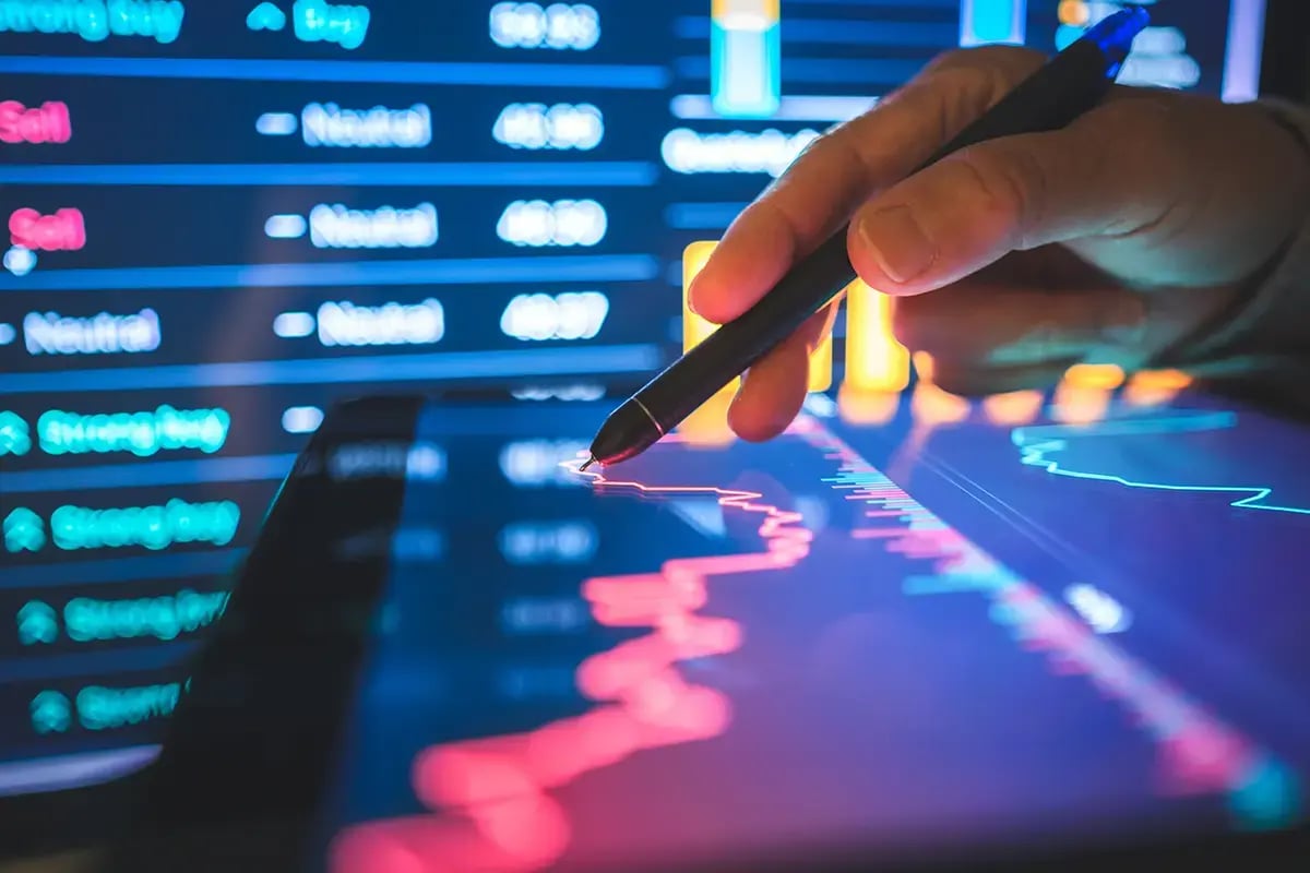 Hand on following a graph or algorithm on a tablet with dashboard in screen as background