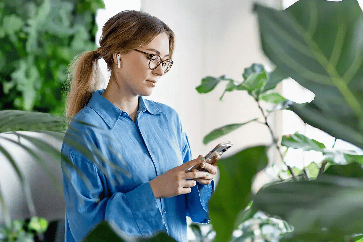 Casually dressed Business Woman reading news on her mobile phone