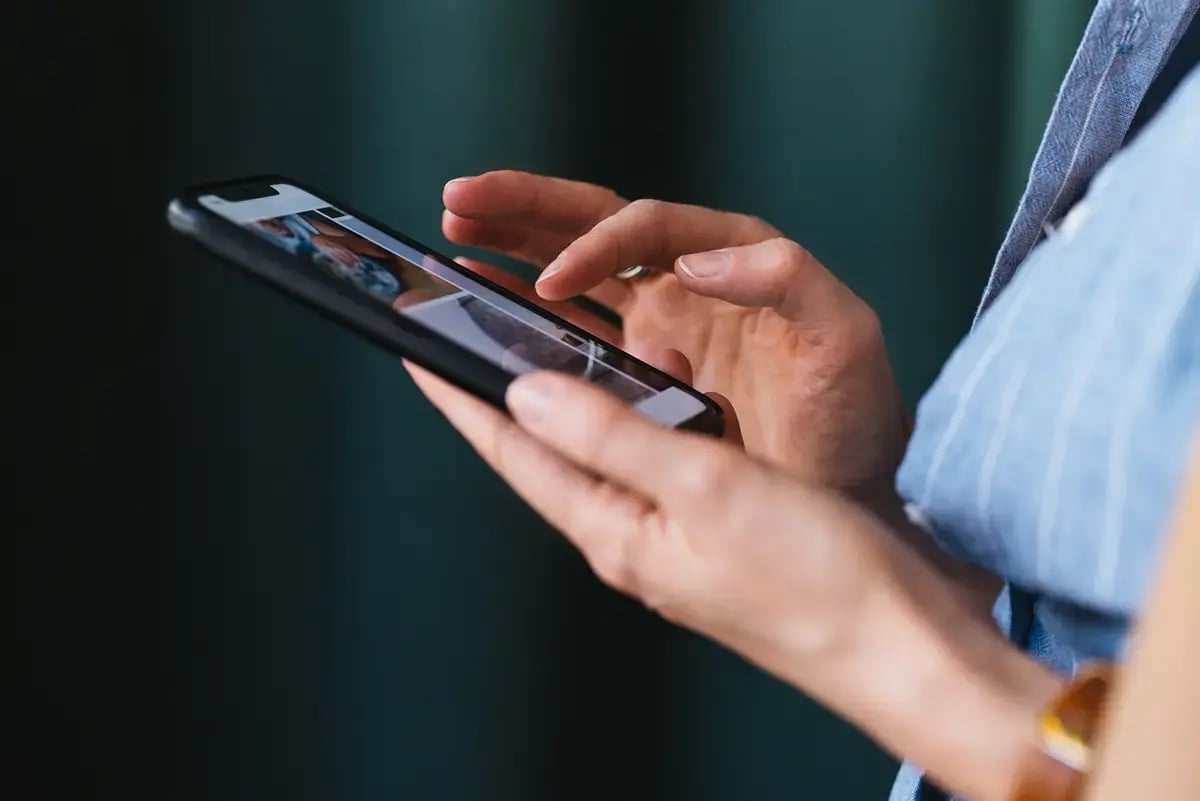 A smart phone being used with two hands