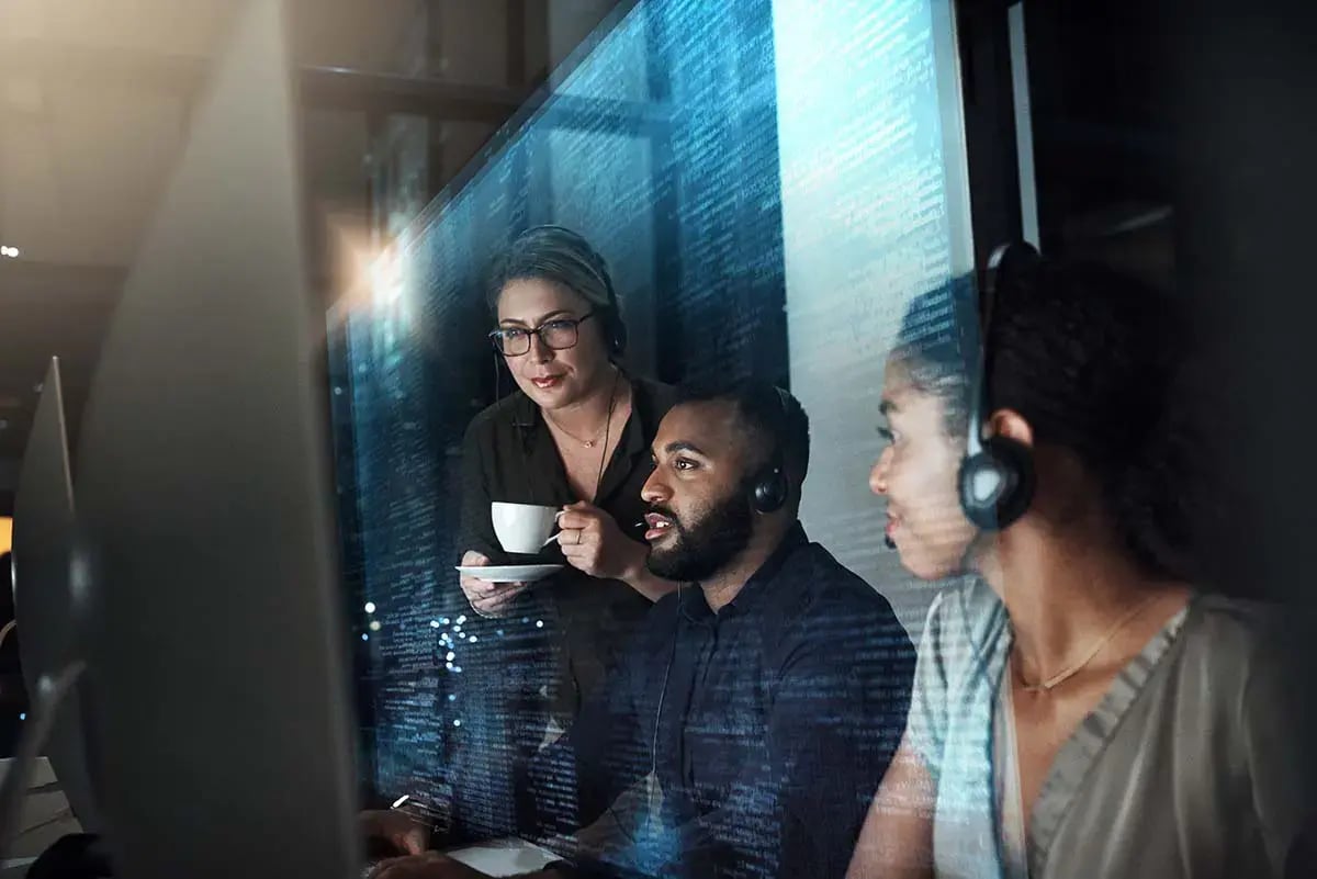 Three Telecom support engineers integrating new data into Telecoms Performance Management