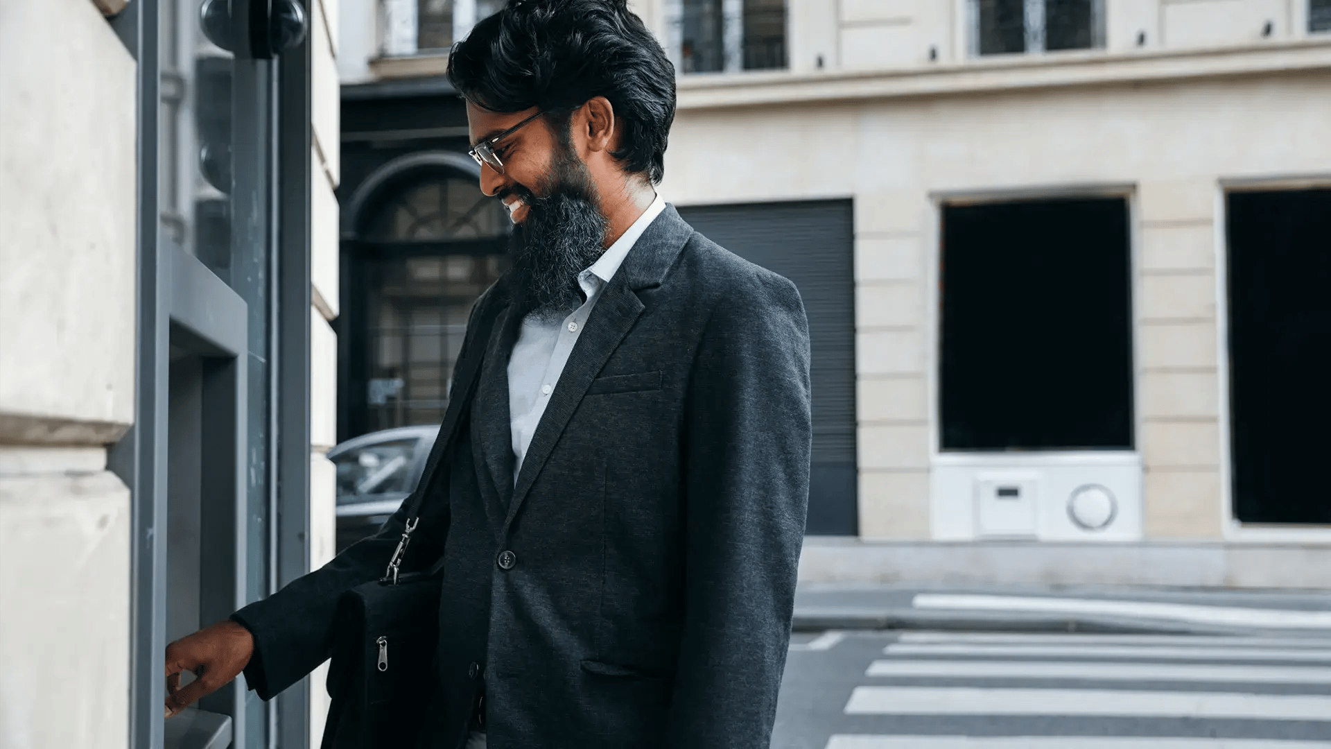 A mobile subscriber make a cash withdrawal at an ATM in the city center