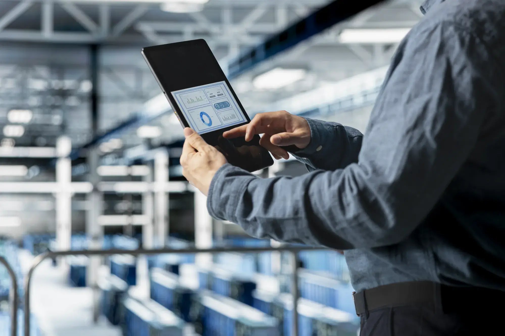 close-up-server-room-employee-analyzing-equipment-metrics-device-screen