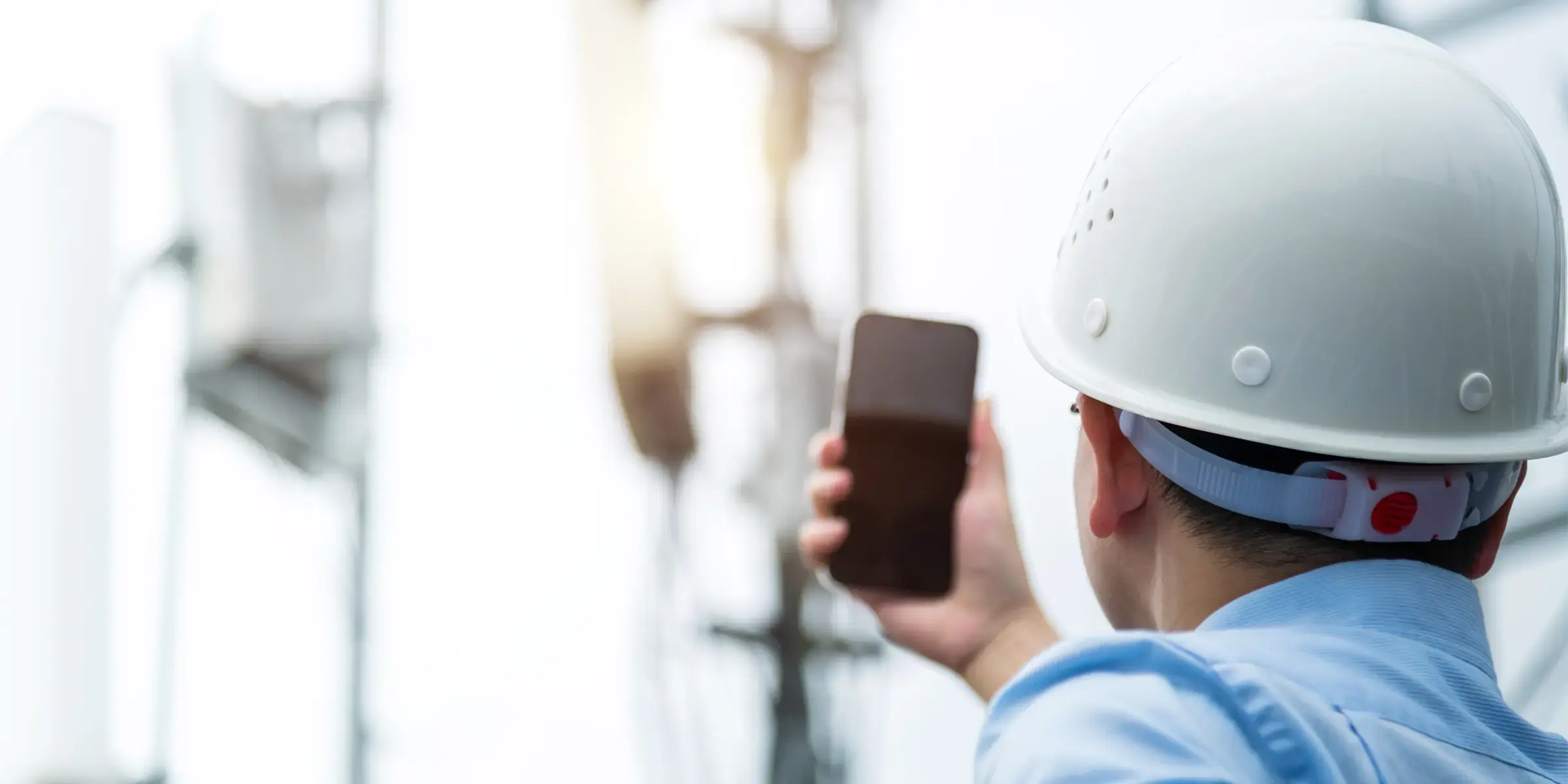 Man in helmet looking at a base station